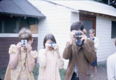 three kids with cameras